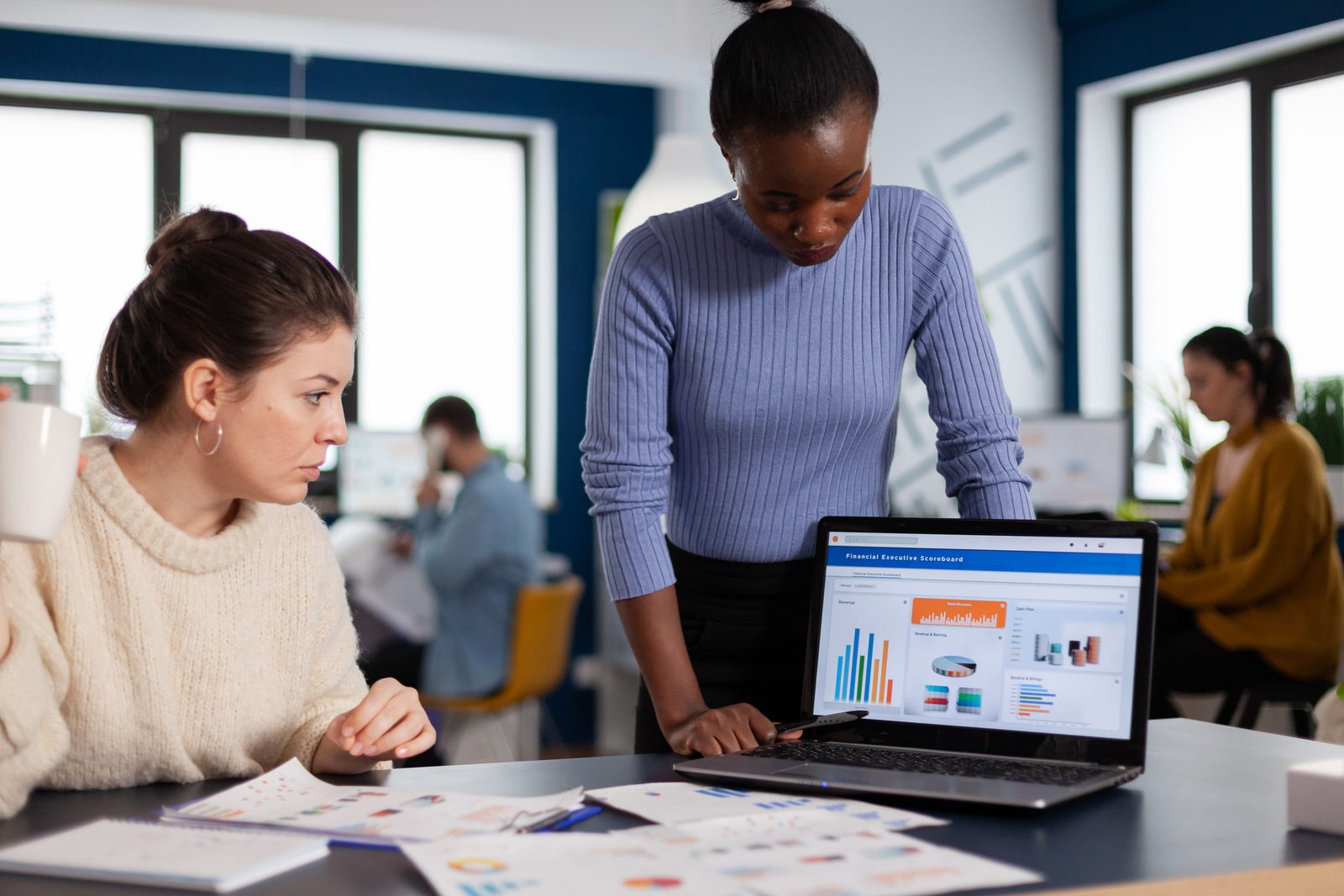 women-analyzing-data-on-laptop-in-modern-office-2026-01-08-02-25-20-utc